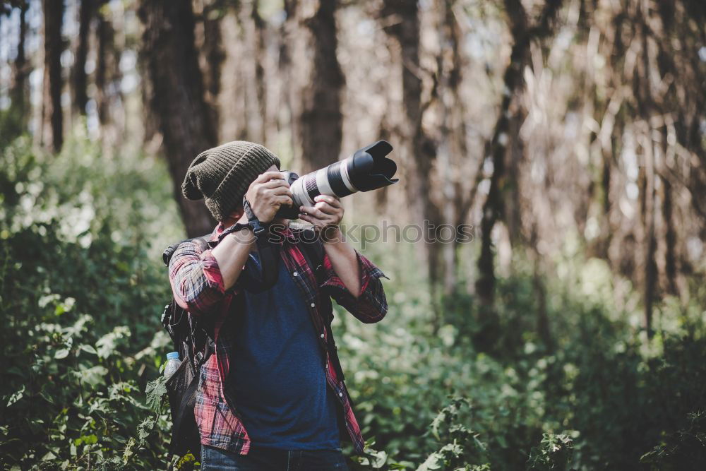 Similar – Hand taking shot of forest