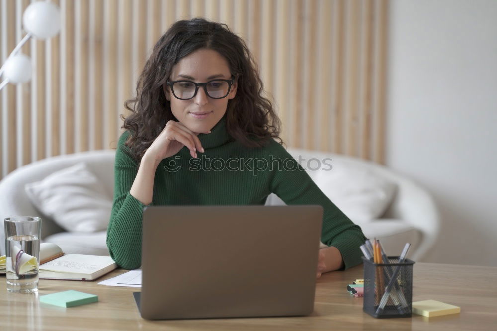 Similar – Young businesswoman working on laptop and drinking coffee