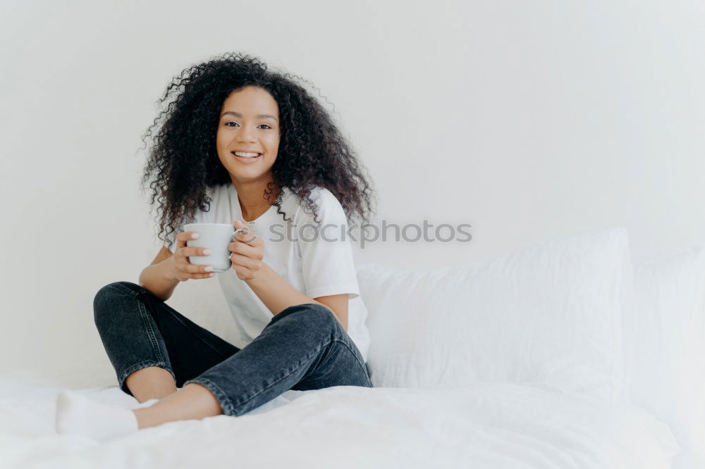 Similar – close up of a pretty black woman with curly hair smiling and lying on bed looking away