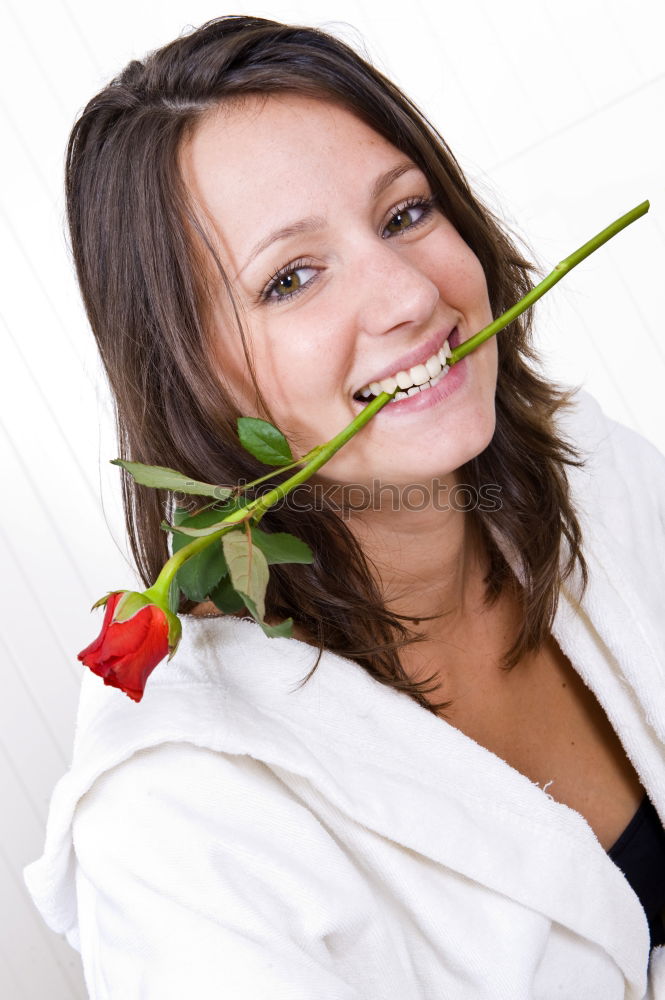 Similar – Redhead woman smelling a flower in a park