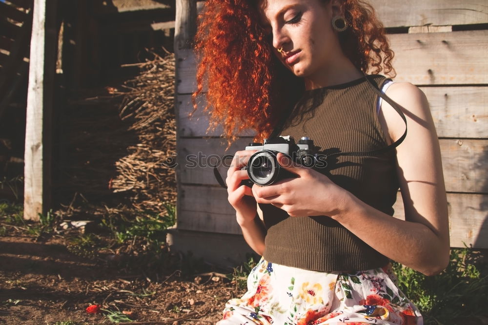 Young redhead photographer woman