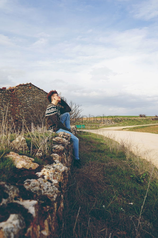 Similar – Young redhead woman walking along an old wall