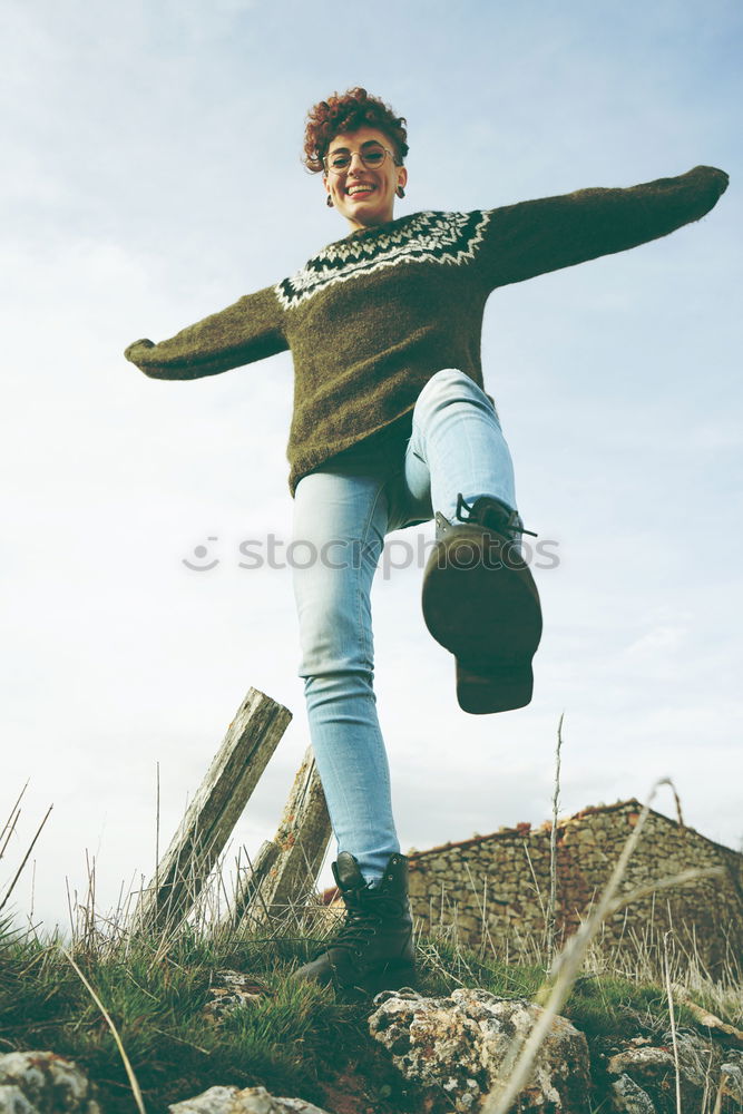 Similar – Young redhead woman walking along an old wall