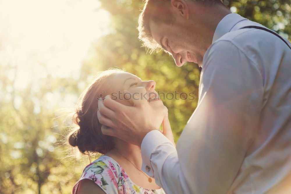 Similar – Back view of senior man holding adorable baby girl in his arms over a nature background