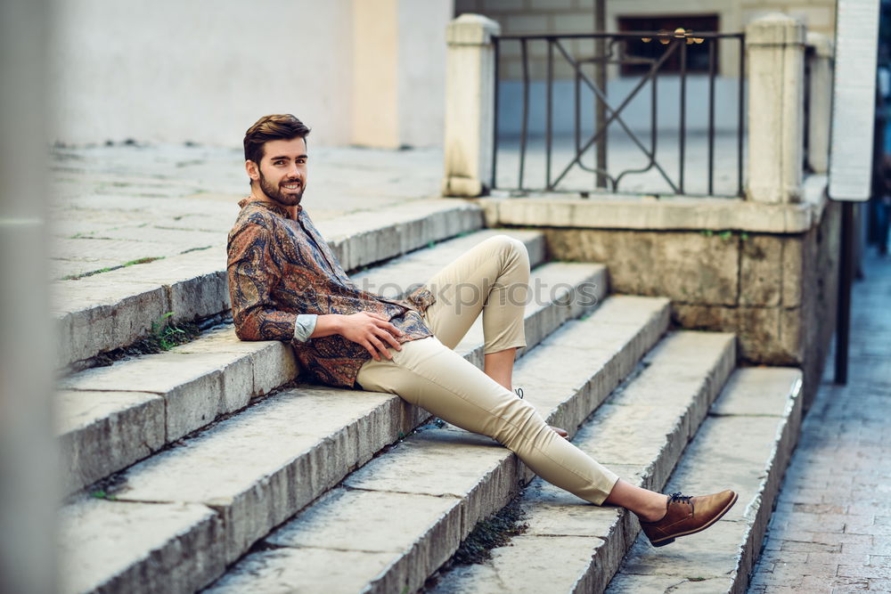 Similar – Young bearded man, model of fashion, sitting on urban step