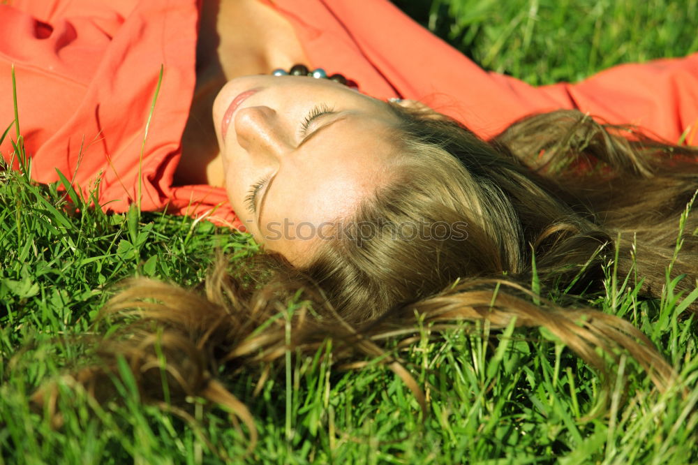 Similar – beautiful woman lying on the grass of a park