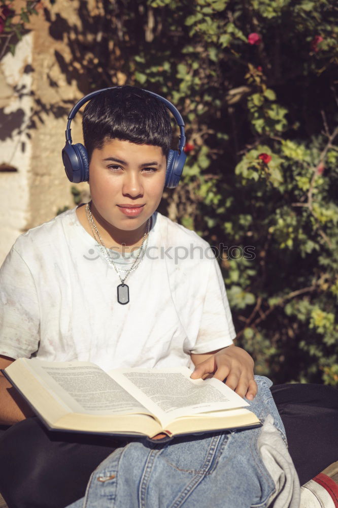 Similar – Portrait of relaxed young boy sitting at the patio door and listening to music from mobile phone