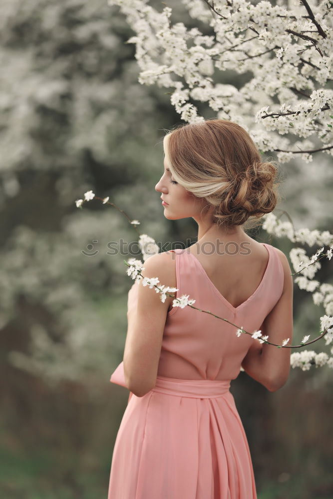 Similar – Young woman in almond flowered field in spring time