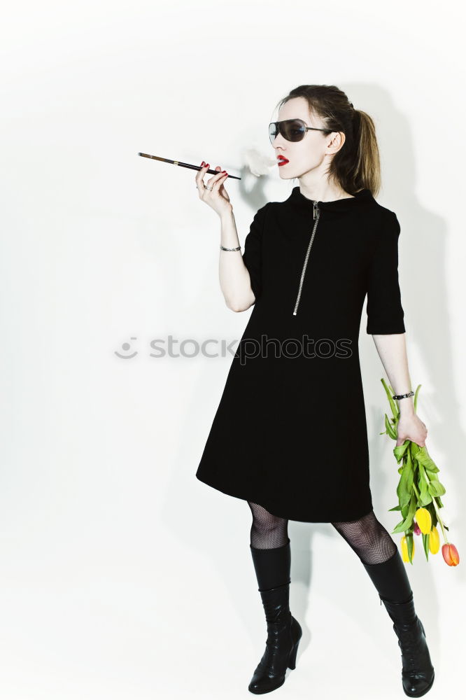 Portrait of senior woman with sunglasses insulting with finger