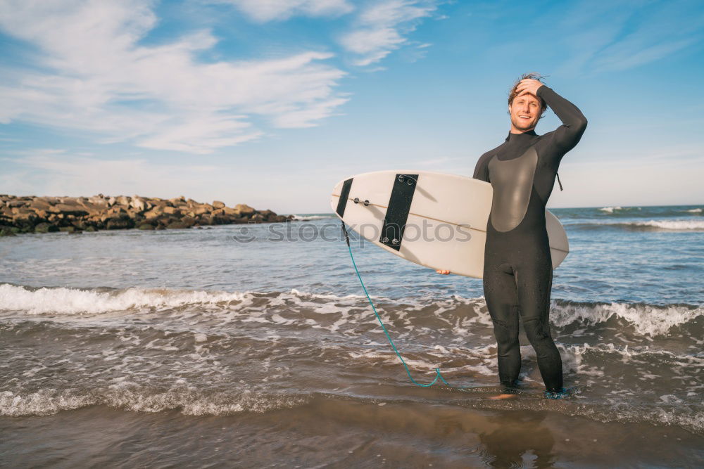 Similar – Man in wetsuit swimming in ocean