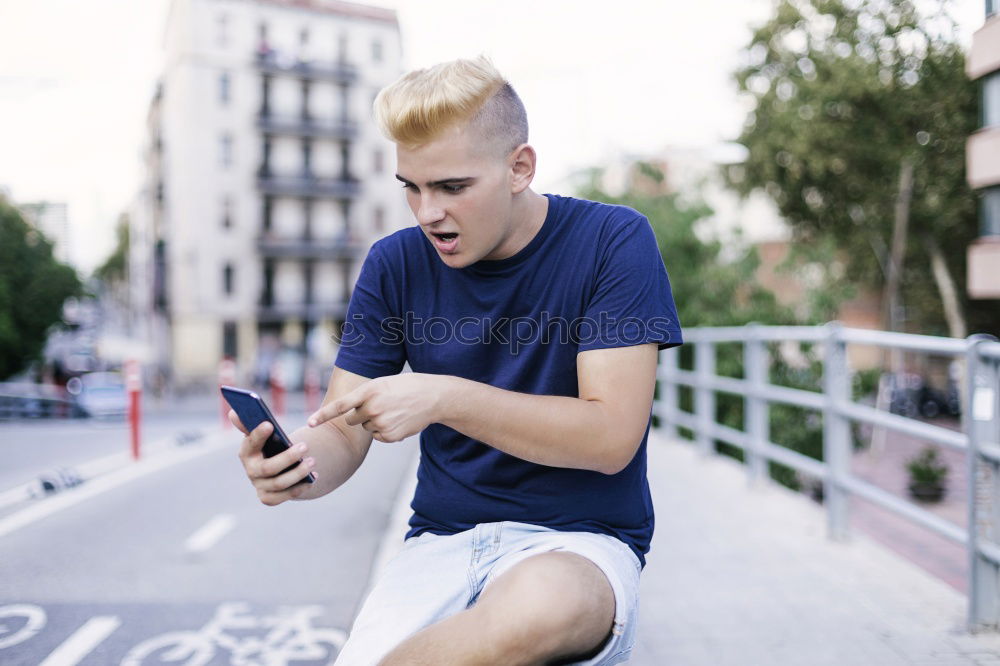 Similar – Image, Stock Photo Young urban man using smartphone in urban background.