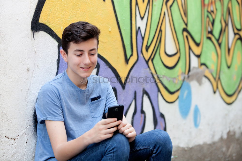 Similar – Image, Stock Photo Young urban man using smartphone in urban background.