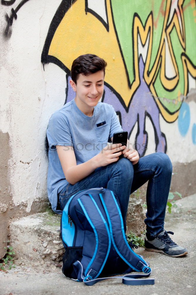 Similar – Portrait of relaxed young boy sitting at the patio door and listening to music from mobile phone