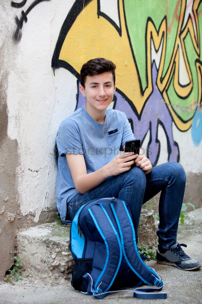 Similar – Portrait of relaxed young boy sitting at the patio door and listening to music from mobile phone