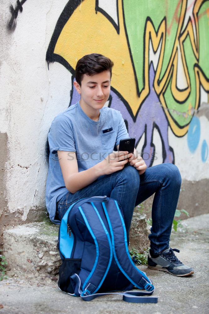 Similar – Portrait of relaxed young boy sitting at the patio door and listening to music from mobile phone