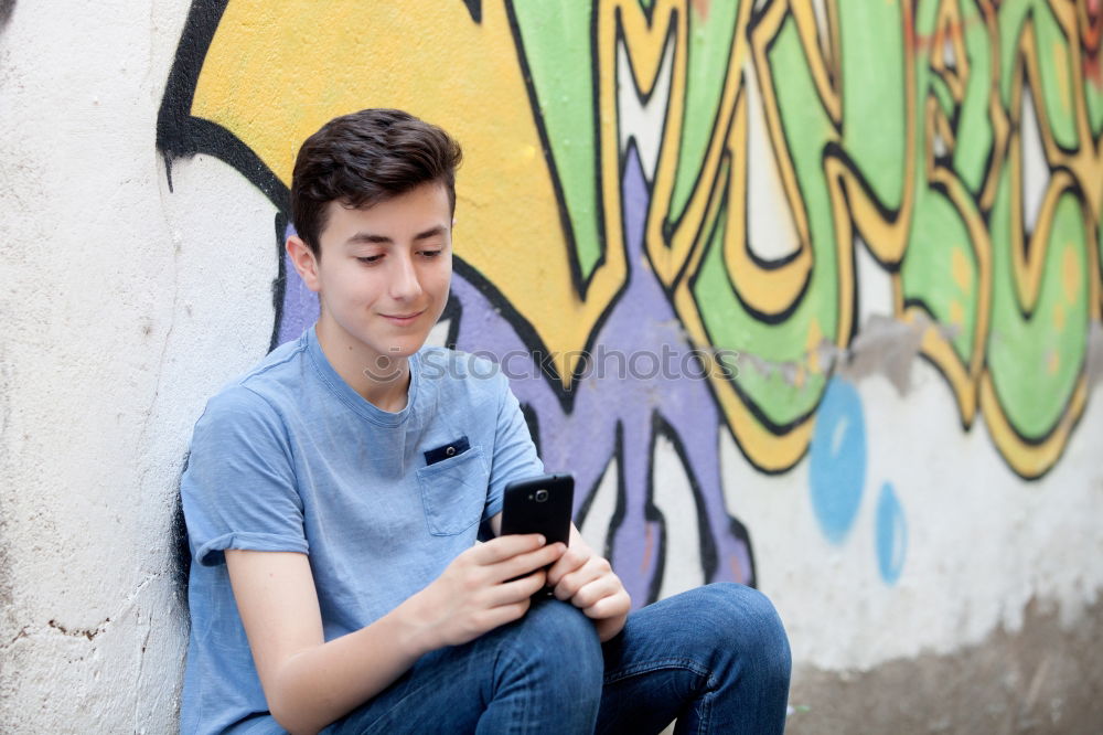 Similar – Image, Stock Photo Young urban man using smartphone in urban background.