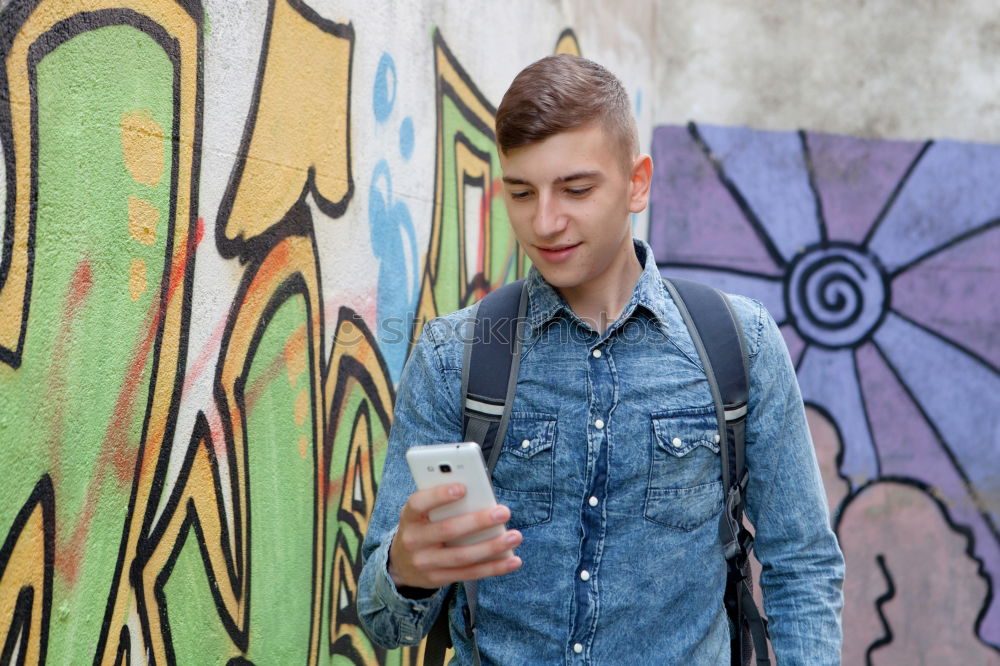 Image, Stock Photo Young urban man using smartphone in urban background.