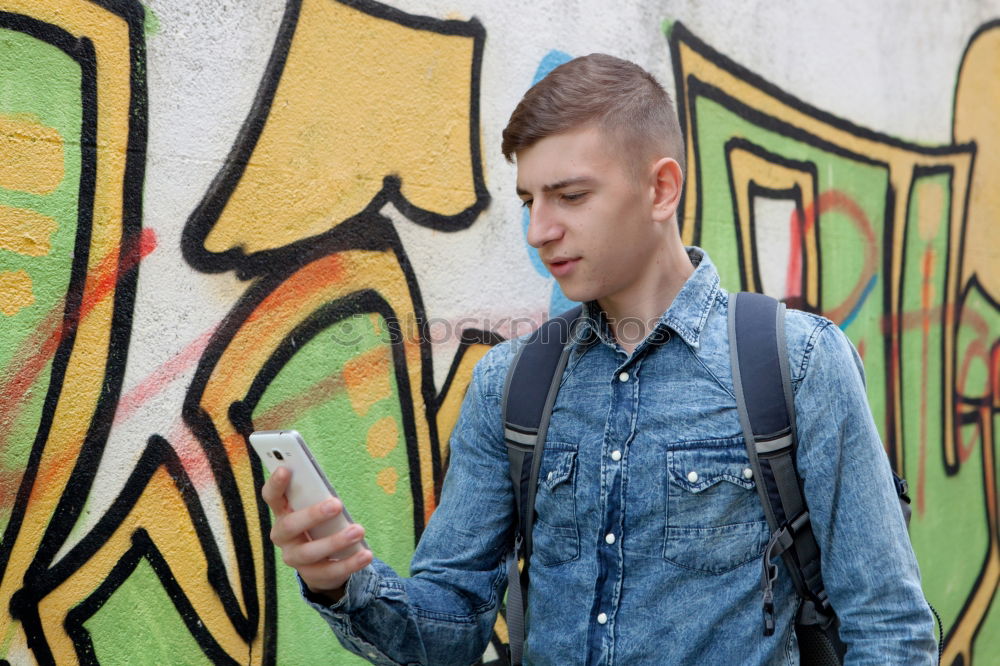 Similar – Image, Stock Photo Young urban man using smartphone in urban background.