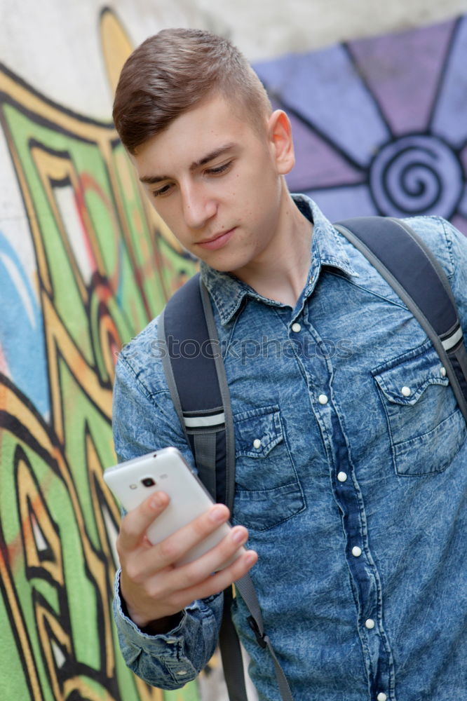 Similar – Image, Stock Photo Young urban man using smartphone in urban background.