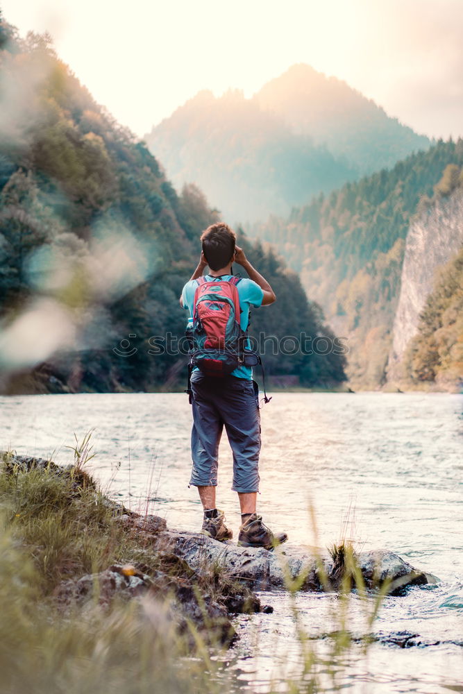 Similar – Image, Stock Photo Young tourist with backpack looks through a binoculars