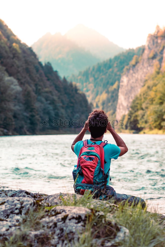 Similar – Image, Stock Photo Young tourist with backpack looks through a binoculars