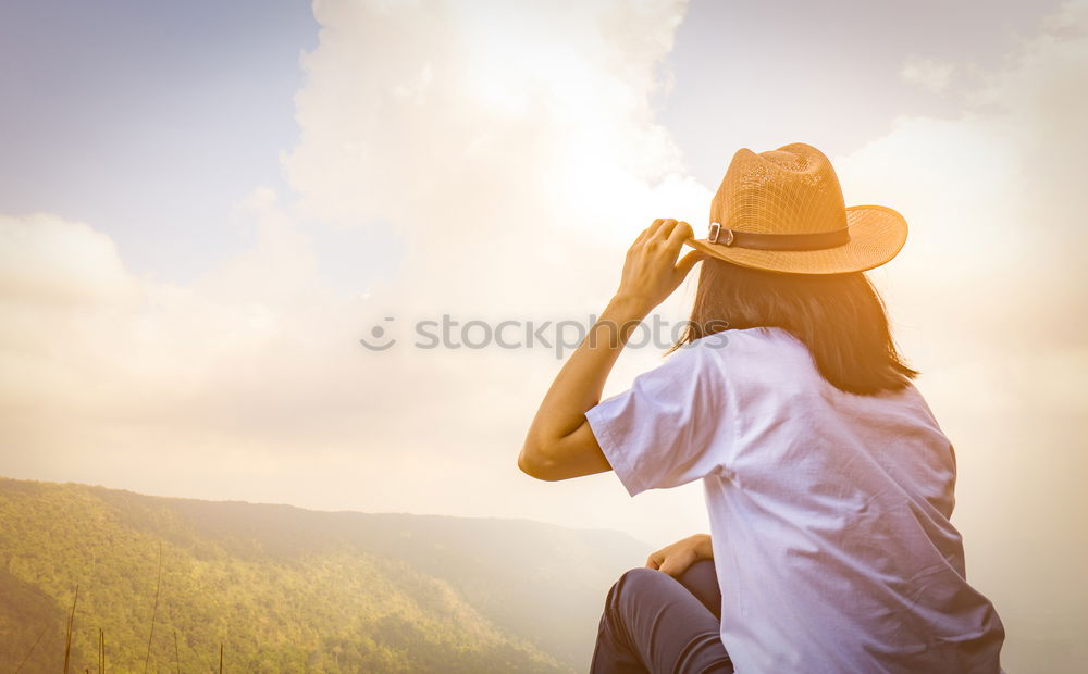 Similar – Tourist standing on cliff in sunny day