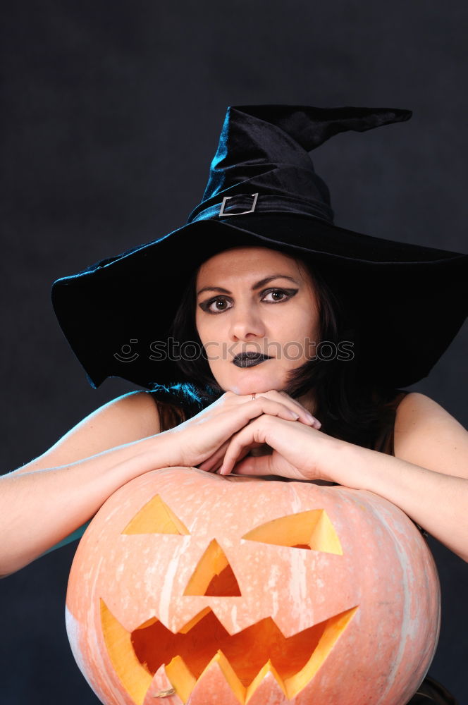 Similar – Image, Stock Photo Happy children disguised decorating a pumpkin at home.