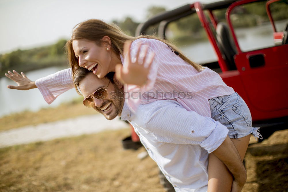 Similar – Happy girlfriend jumping on boyfriend’s back in the street