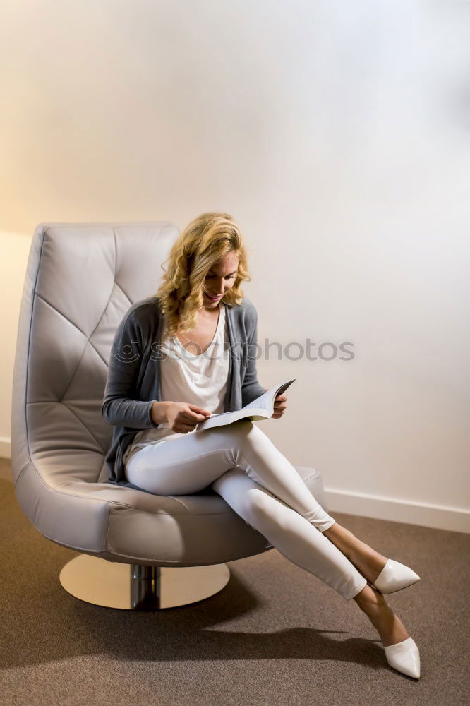 Similar – Smiling businesswoman with magazine and crossed legs sitting chair against of modern wall