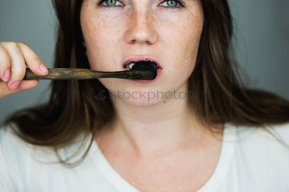 Crop woman eating sushi