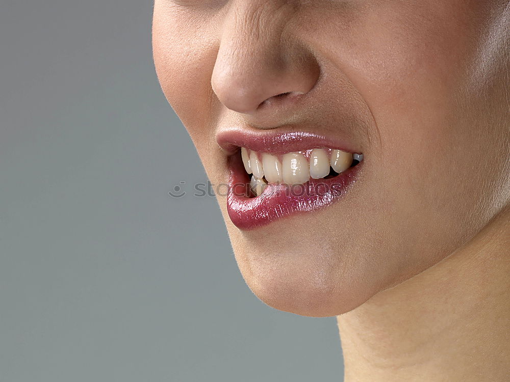 Close-up of a female mouth with vampire teeth and tongue