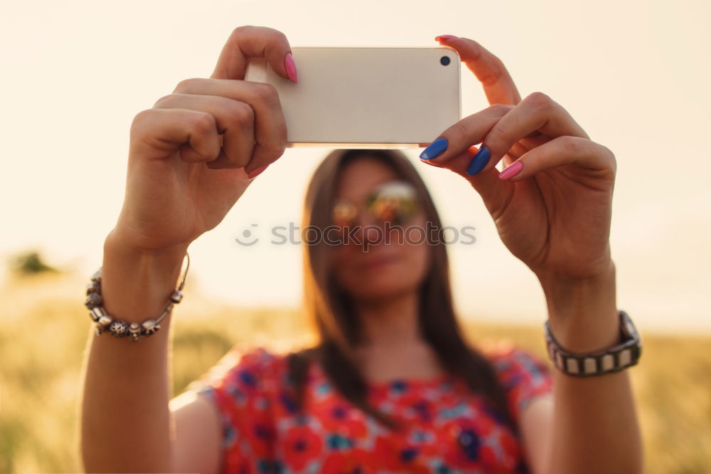 Similar – beautiful young woman using mobile phone and smiling