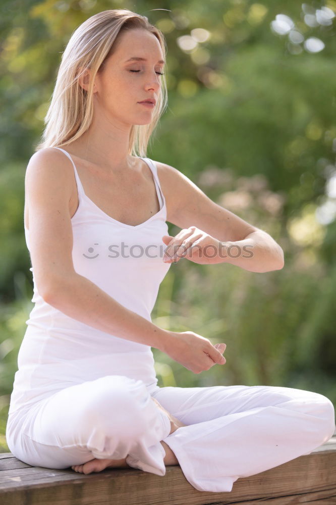 Similar – Young woman doing yoga in nature. Lotus figure.