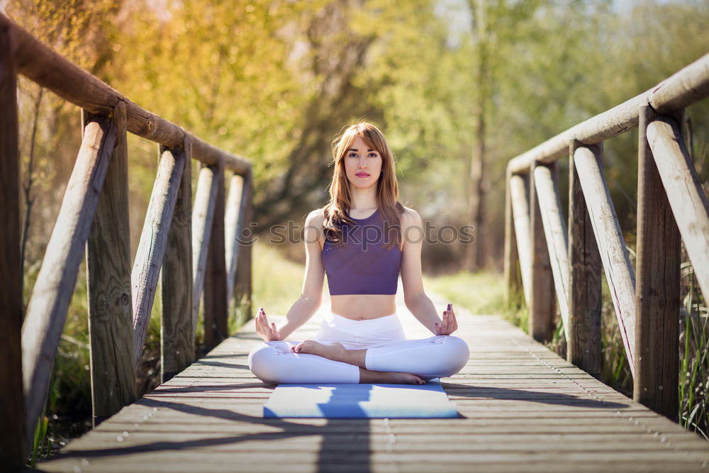 Similar – Young woman doing yoga in nature. Lotus figure.