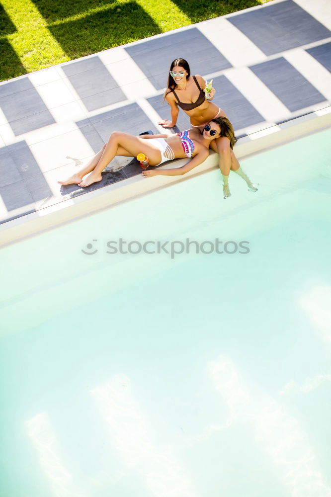 Similar – Two young women in swimsuits relaxing in the swimming pool