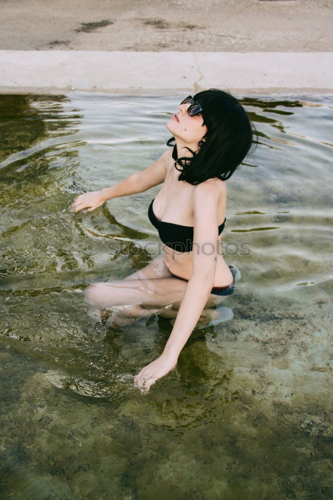 Young woman in a pool enjoying the water