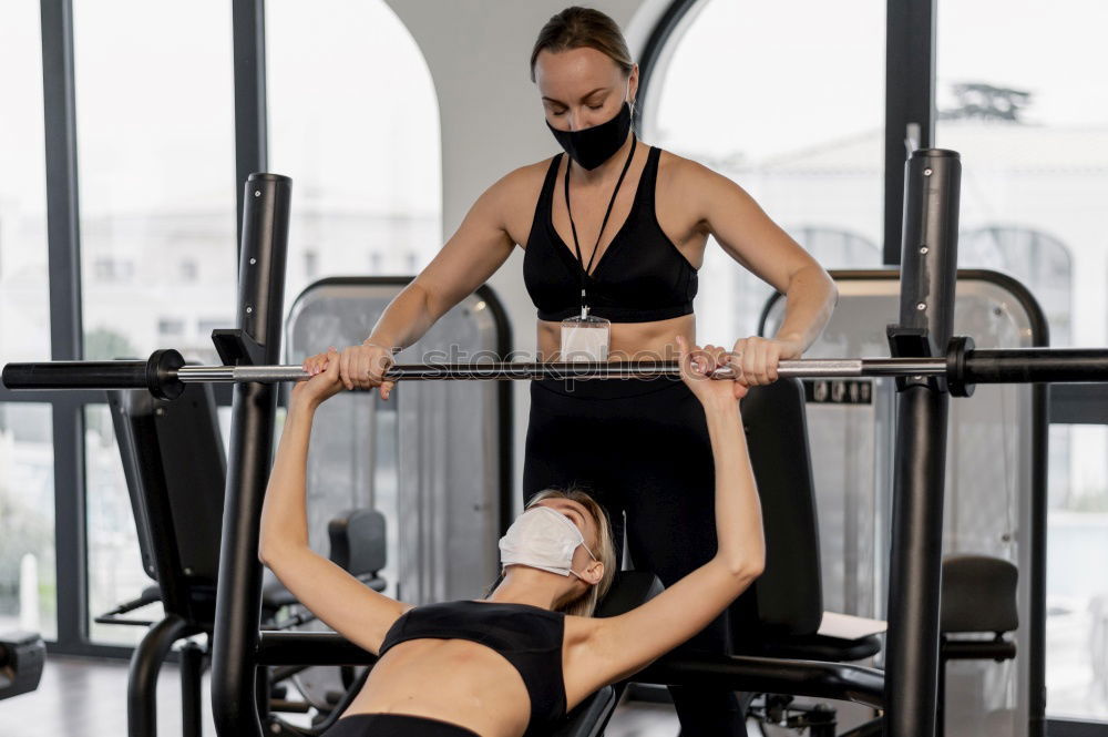 Similar – Personal trainer teaching to woman in suspension training