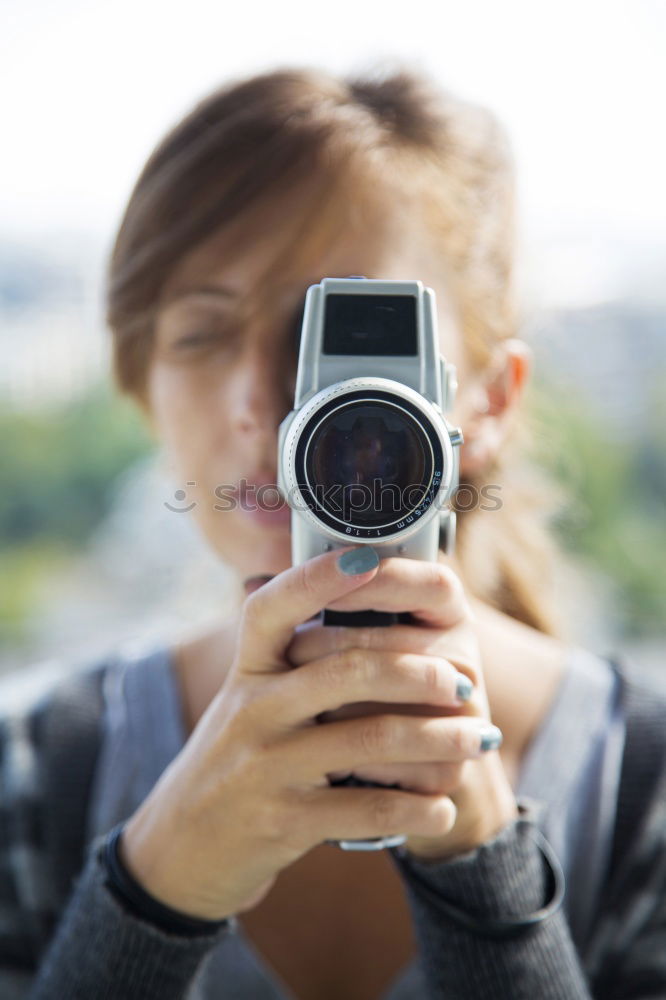 Similar – close up portrait of a young woman holding a camera. Photography concept