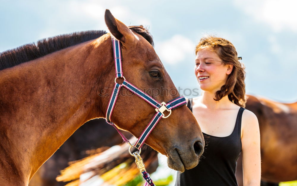 Similar – Young dark-haired curly woman with horse in stable