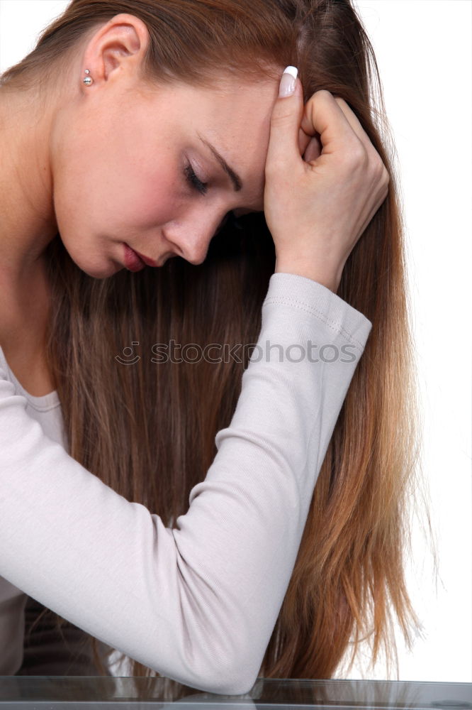 Similar – one sad woman sitting near a wall and holding her head in her hands