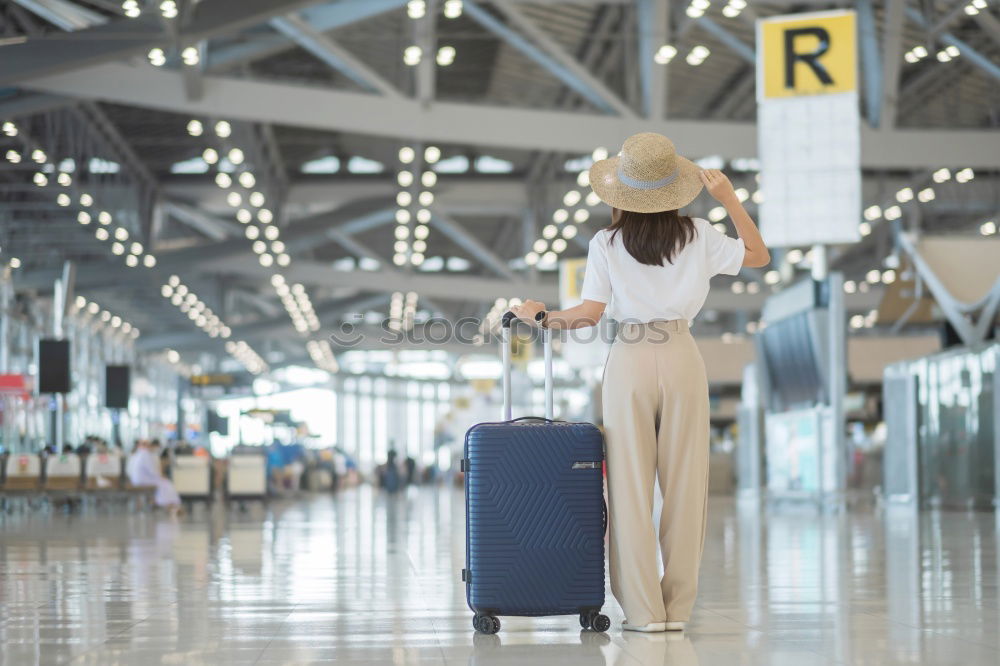 Similar – Image, Stock Photo Black Woman looking at the timetable information panel in the airport with a suitcase