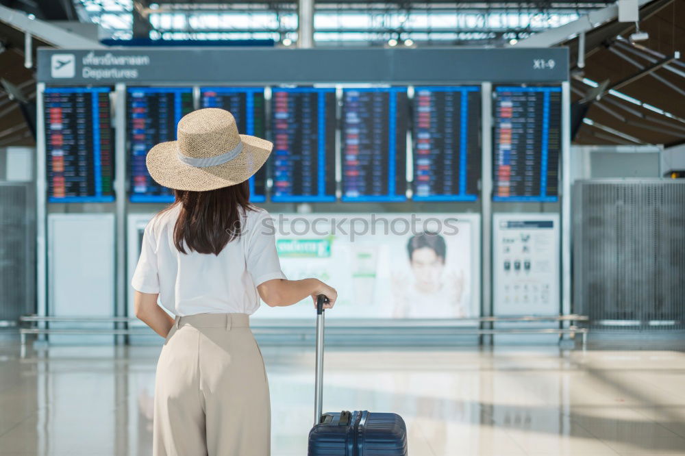 Similar – Image, Stock Photo Black Woman looking at the timetable information panel in the airport with a suitcase