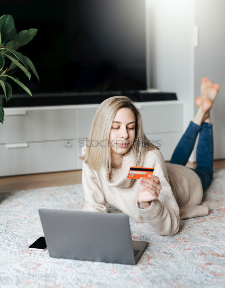 Similar – african happy woman lying on couch with laptop