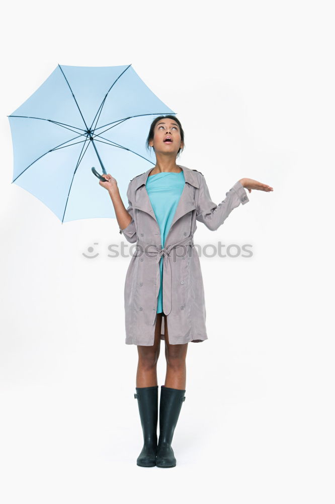 Similar – Woman with umbrella in front of green wall