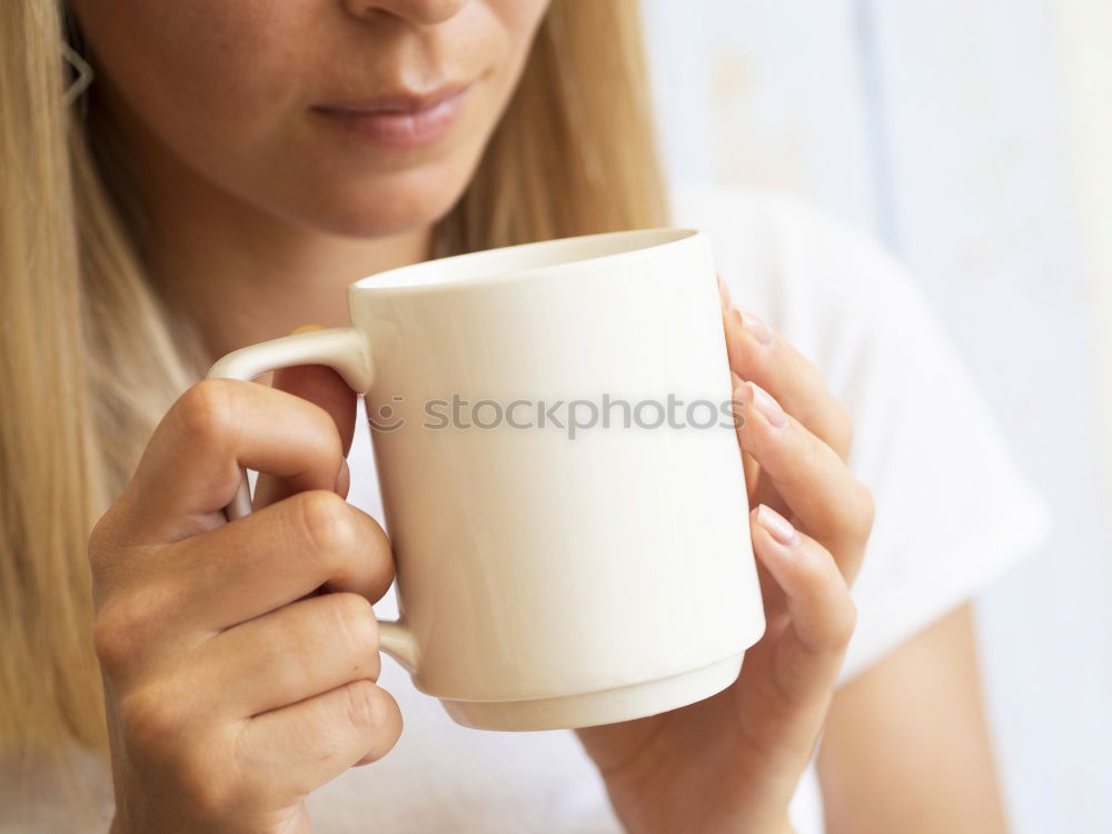 Similar – Happy young woman holding a cup of tea or coffee