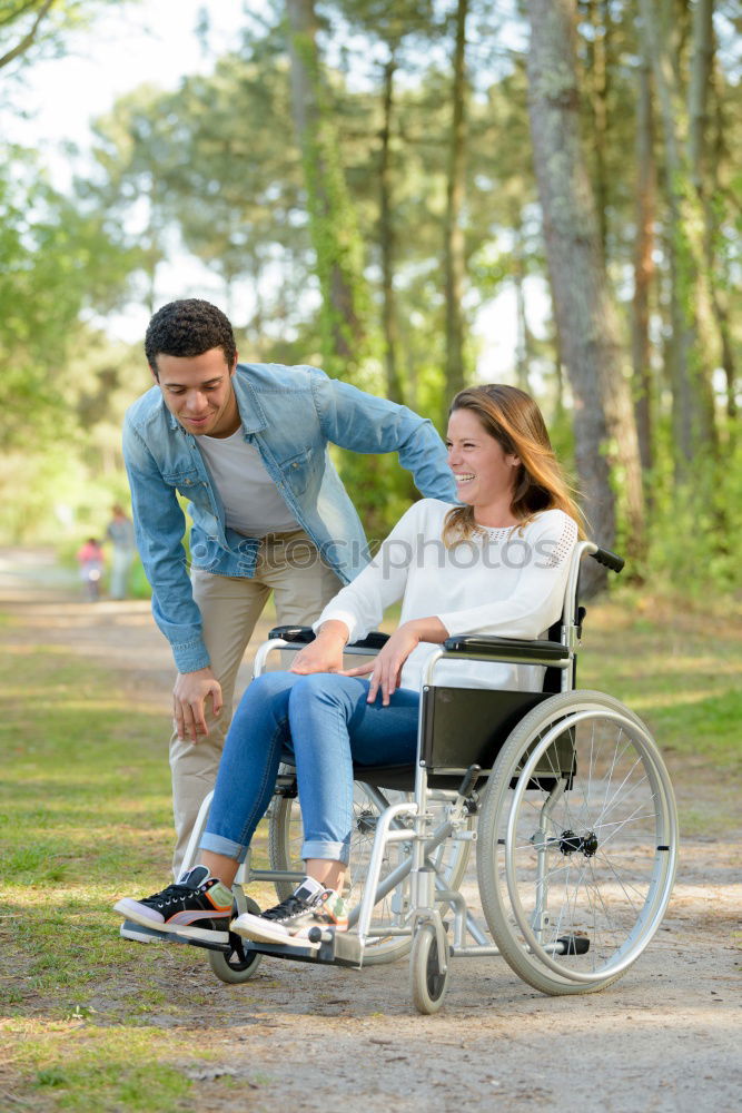 Similar – Foto Bild Frau und ihr Freund im Rollstuhl machen einen Spaziergang durch den Park an einem Fluss und genießen den Herbst