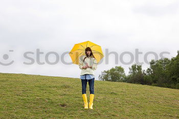 Similar – Image, Stock Photo Woman walking with umbrella in front of green wall