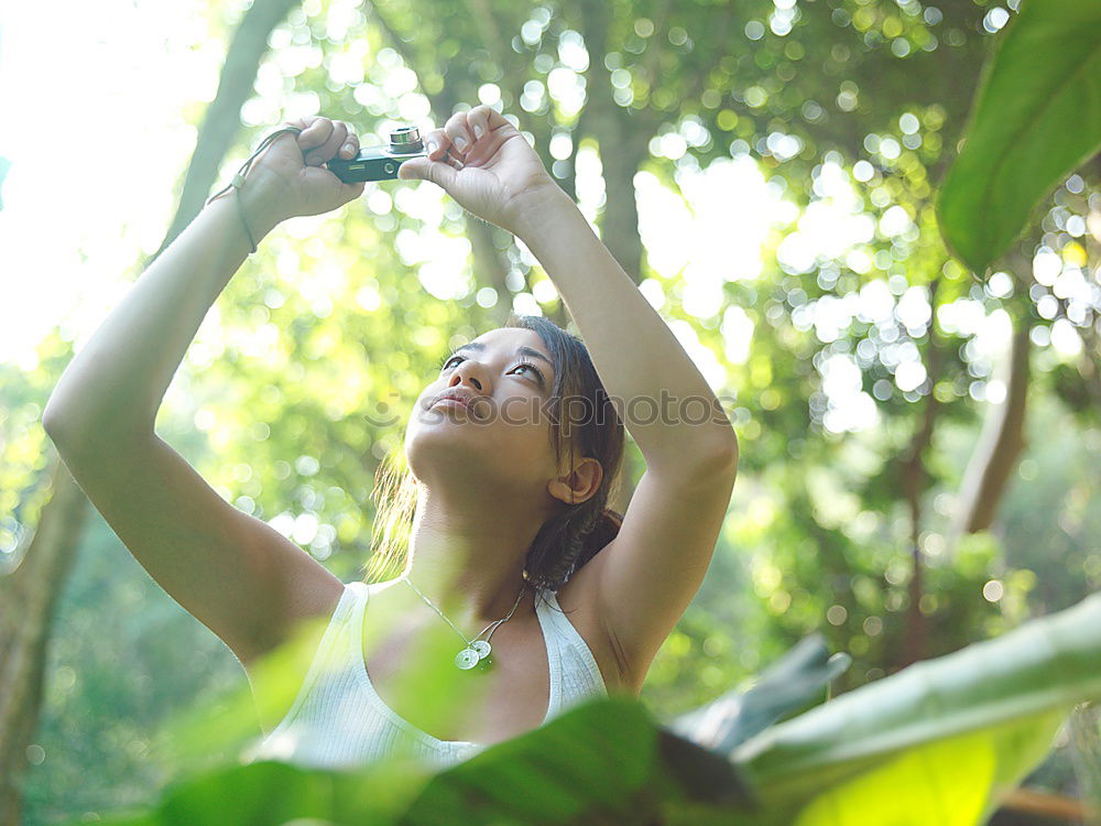 Similar – Woman in swimsuit sitting on grass holding pineapple