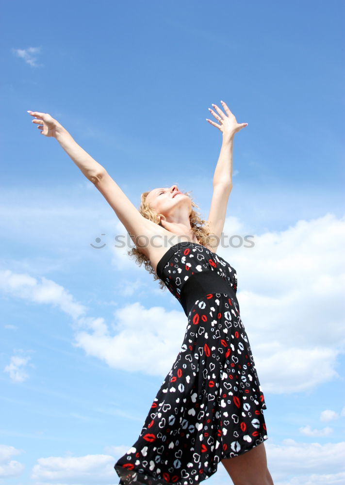 Similar – Young girl in jumpsuit with flower pattern jumps to the left in front of blue sky