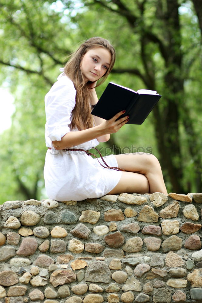 Student Reading Book at the Park